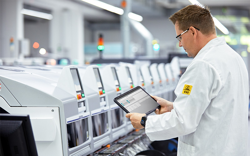 Employee checking data at machine